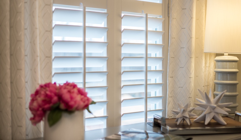 Plantation shutters by flowers in Charlotte